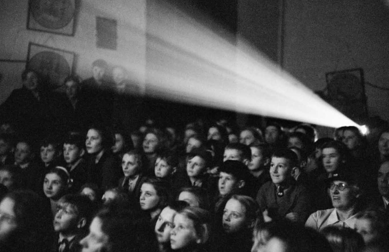 Fotografia di Bet Hardy, sala cinema con proiettore alle spalle; bianco e nero; 1940